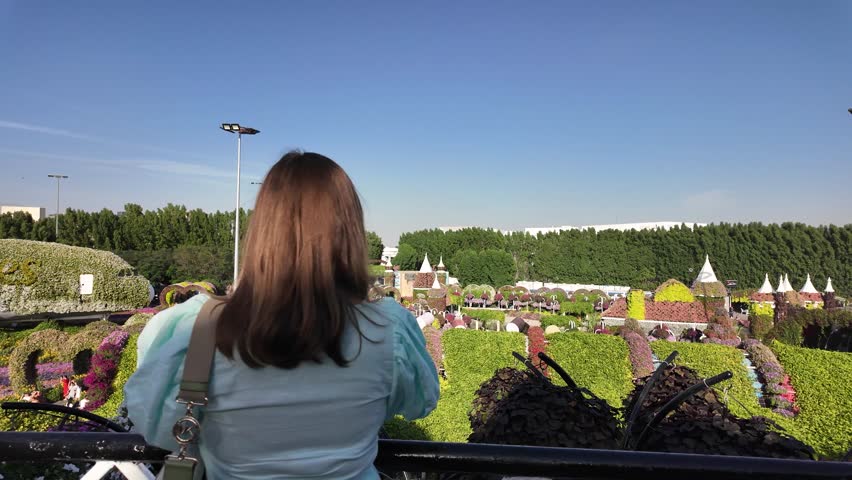 A girl walks in the miracle garden