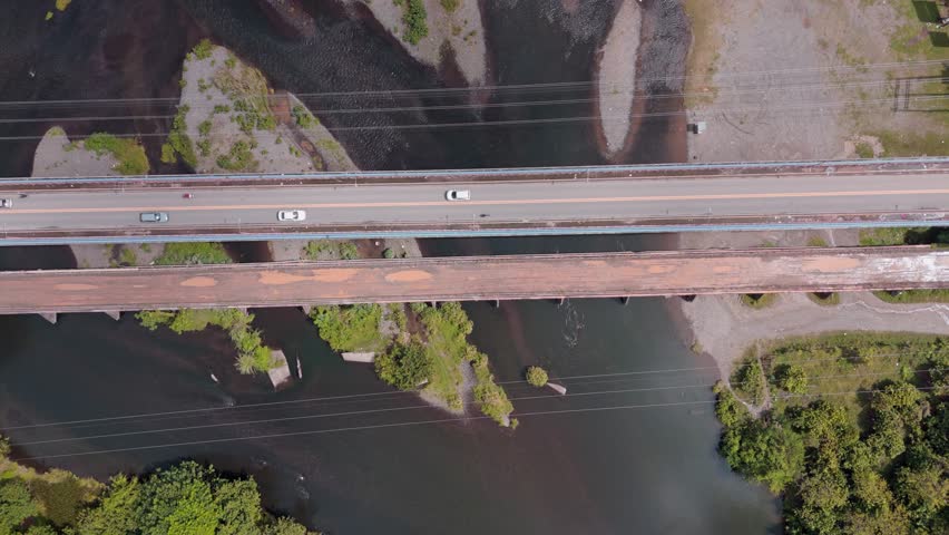 Rio Yuna, bridge crossing river, Cotui in Dominican Republic. Aerial top-down ascending