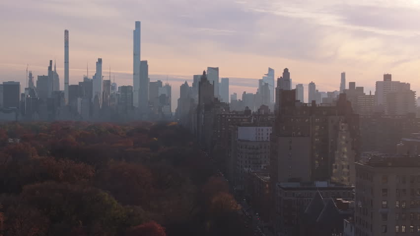 Journal Square skyscrapers construction city in Jersey City, New Jersey, aerial view in a foggy autumn day, featuring traffic flowing on highway at dusk