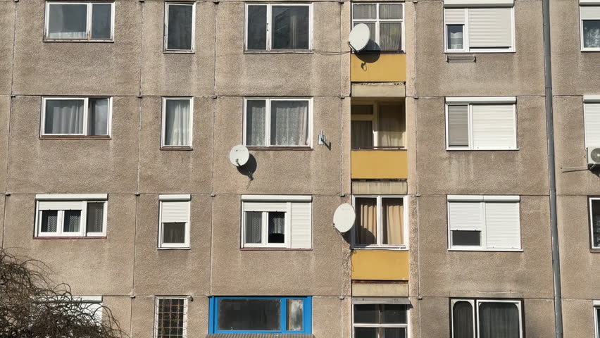 Facade of an old apartment building with satellite dishes