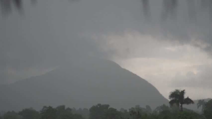 Misty mountain covered in heavy rain under a stormy sky in rural Haiti.