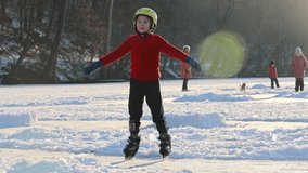 Happy child, boy, casually dressed, skating on a frozen lake during the day, beautiful sunset in the forest behind, having fun - Powered by Shutterstock - Get 15% off with code: PIKWIZARD15