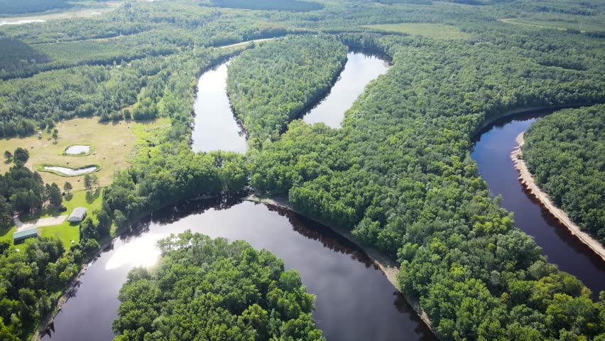 Flying over a very winding river and forest in Northern Minnesota near the border of Canada