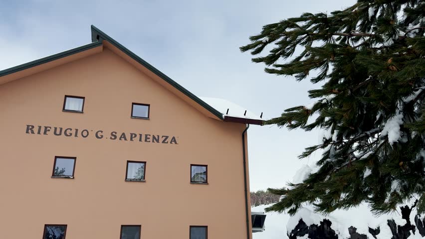 Rifugio Sapienza Etna Sud tourist area on the Etna volcano in winter. Ski resorts in Sicily. Etna South with sea view. Snow on Etna. Silvestri craters covered in snow. Shops and restaurants.