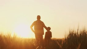 Farmer and his son in front of a sunset agricultural landscape. Man and a boy in a countryside field. Fatherhood, country life, farming and country lifestyle concept. - Powered by Shutterstock - Get 15% off with code: PIKWIZARD15