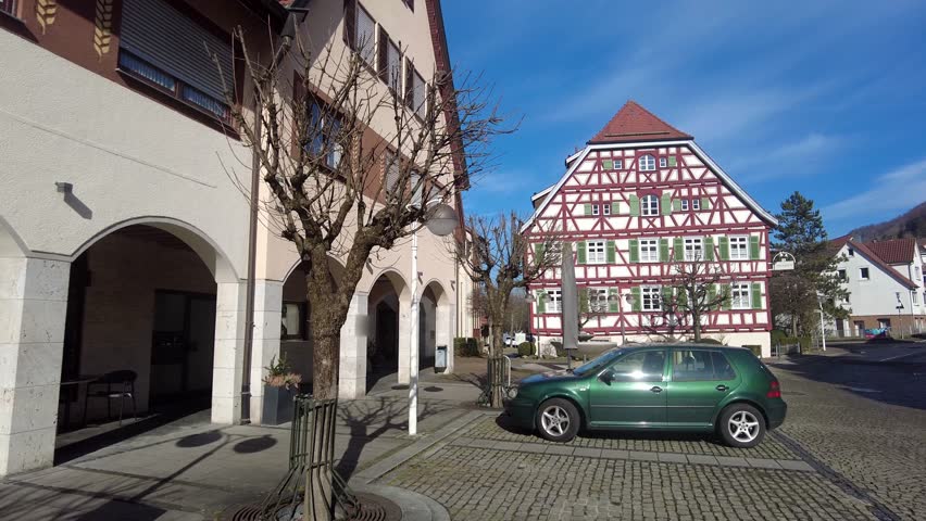 Central Square of Bad Überkingen, Germany on a Sunny Day - Fachwerk Houses, Café, Fountain, and Cobblestone Streets