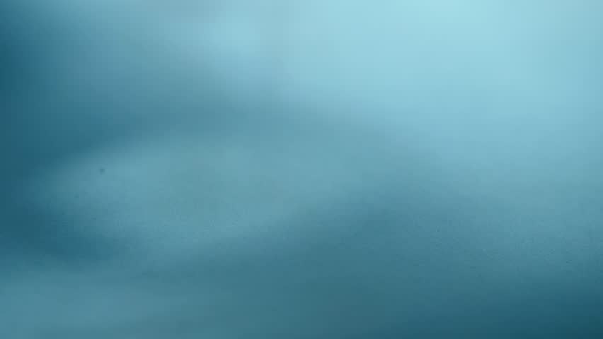 Blue wisps of smoke swirling swirling medium 4k shot selective focus