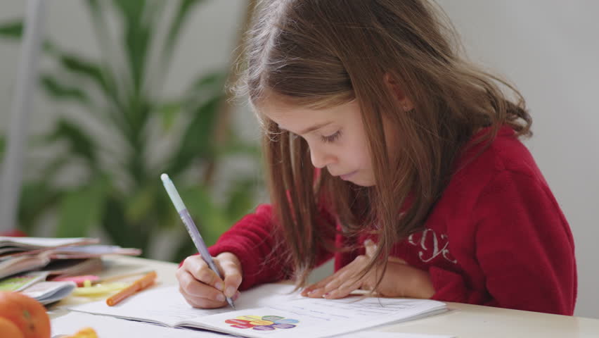 Girl creating greeting card at home, side view, immersed in her creative process. A fun childhood hobby that sparks her imagination and artistic expression