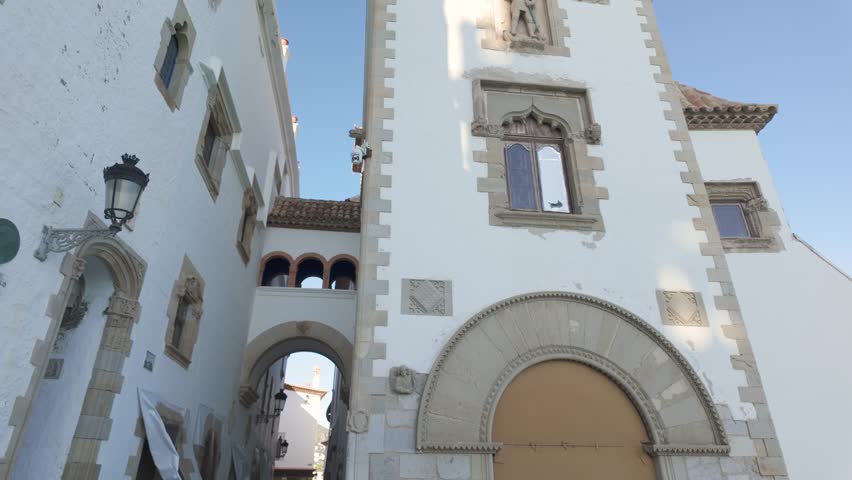 Elegant historic building with arched entrance and stone details on Carrer de Fonollar Sitges Spain
