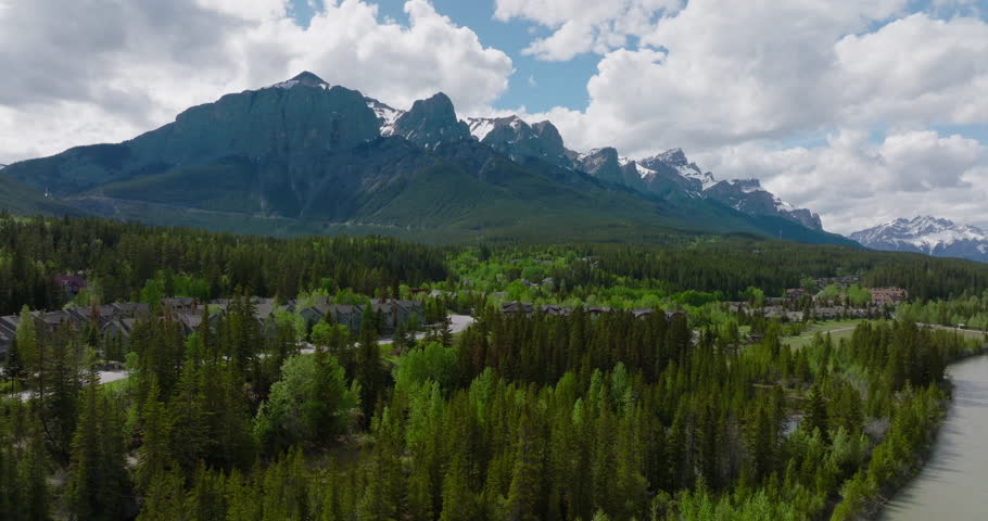 Beautiful Aerial Drone Shot of Canmore Alberta in Spring with Snow of The Rocky Mountains