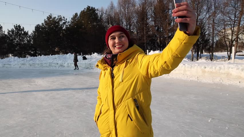 A woman with a child talks video communication link in the winter outdoors