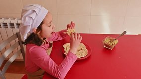 Young Girl Enjoying Pita Bread With Homemade Guacamole in Kitchen - Powered by Shutterstock - Get 15% off with code: PIKWIZARD15