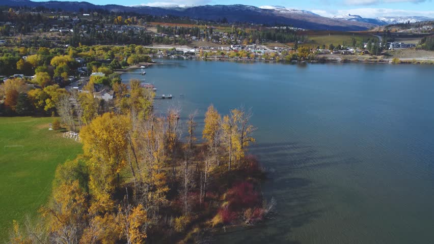 Beautiful Lakeside Autumn Colored Trees in Canadian Provincial park Overlooking Calming Serene Wood Lake Horizon. Okanagan, British Columbia. Tranquil Nature Landscape. Lakecountry, BC, Canada