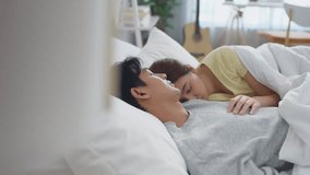 Asian new marriage couple sleep on bed together in bedroom at home. Attractive young man and woman lying down comfortable, enjoy early resting in morning activity in house. Family relationship concept - Powered by Shutterstock - Get 15% off with code: PIKWIZARD15