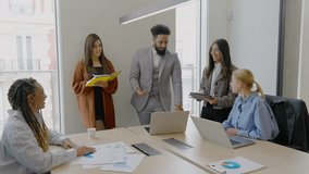 In a modern office, a diverse team of skilled professionals engages in dynamic conversations that foster teamwork, collaboration, and innovative ideas, driving significant progress in their projects - Powered by Shutterstock - Get 15% off with code: PIKWIZARD15