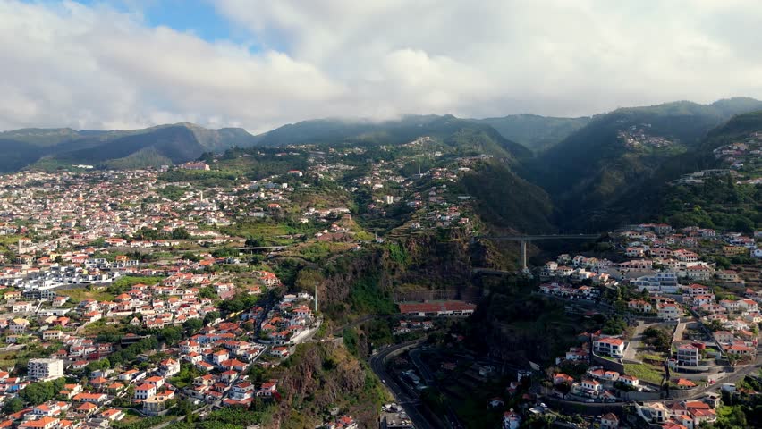 Aerial wide angle view cityscape of Funchal Madeira Portugal island with landscape mountains and highway bridge