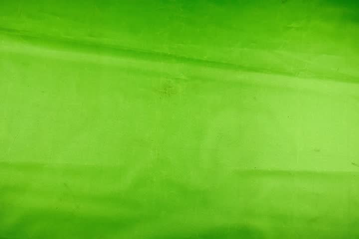 A close-up studio shot features two gold metallic foil balloons shaped like the number 13 against a vibrant lime green background
