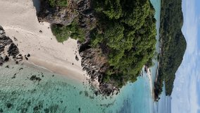 Aerial drone footage of Coron Island, Philippines, showcasing a stunning tropical paradise with pristine beaches, turquoise waters, and lush green landscapes. Vertical video. - Powered by Shutterstock - Get 15% off with code: PIKWIZARD15