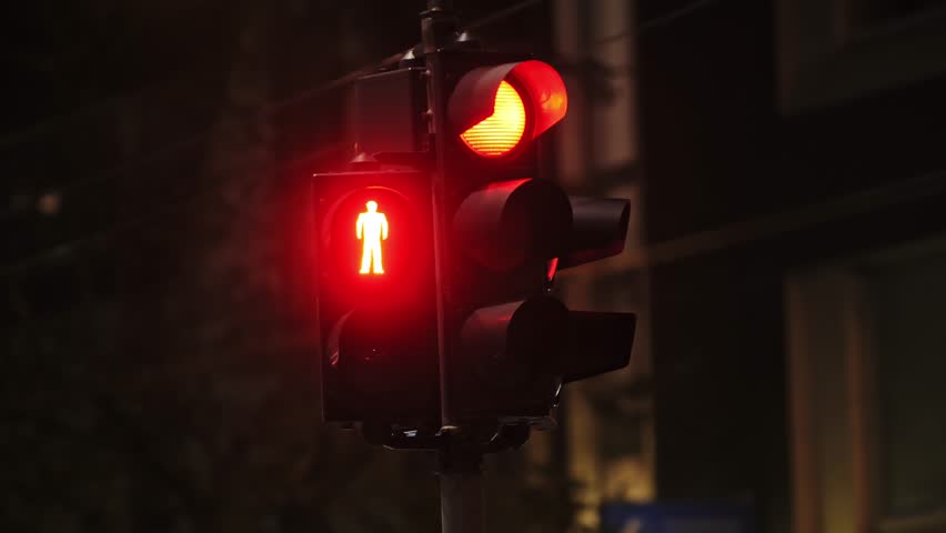 Traffic light sequence shifting from red to green, signaling pedestrians to walk