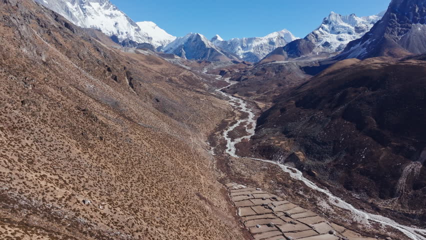 Massive Mount Everest towering over winding Nepalese valley near Dingboche, unveiling breathtaking Himalayan panorama with snow mantled peaks