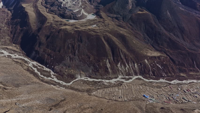 Majestic Mount Everest dominates the landscape, snow capped peak piercing the sky, surrounded by rugged terrain, nature grandeur in Nepal