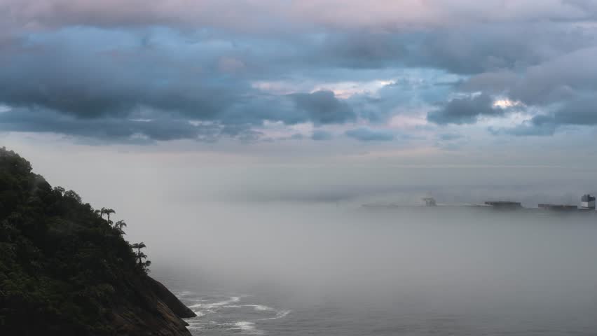 Giant container ship entering Rio Bay under thick fog