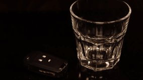 Pouring alcohol into a glass with a car key sitting next to it. - Powered by Shutterstock - Get 15% off with code: PIKWIZARD15