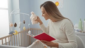 Woman reading book to baby in cozy bedroom with plush toy and cradle in warm indoor setting highlighting nurturing care and bonding. - Powered by Shutterstock - Get 15% off with code: PIKWIZARD15
