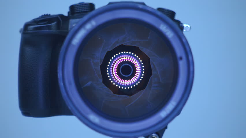 A professional camera on a tripod with an expensive lens with an aperture of 1.5 and a focal length of 85 mm, which reflects the ring LED light. Closeup. Macro