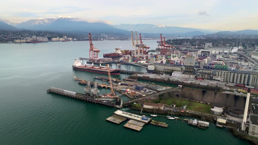 Industrial Port Of Container Terminal With Cargo Ship In Downtown Eastside In Vancouver, Canada. - aerial shot