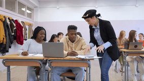 Experienced teacher guiding high school students during collaborative learning session, providing academic support and personalized instruction using digital technology - Powered by Shutterstock - Get 15% off with code: PIKWIZARD15