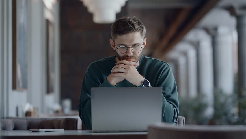Startup Owner Or Investor Looking At Laptop Display, Working Remotely From Cafe, Medium Portrait