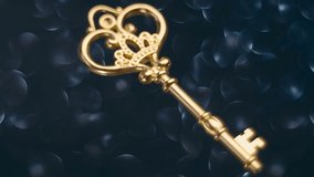 Beautiful decorative golden key rotates on a blurred background. Closeup. Macro - Powered by Shutterstock - Get 15% off with code: PIKWIZARD15