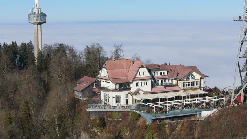 historical building atop uetliberg mountain hotel restaurant communication tower zurich views background via clear day close up aerial drone switzerland