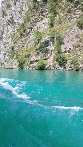 Boat ride on the blue lagoon in the canyon among rocks and trees