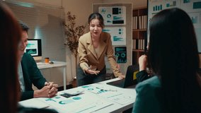 Asian businesswoman leading office meeting presenting financial charts - Powered by Shutterstock - Get 15% off with code: PIKWIZARD15