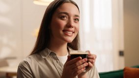 Camp peaceful cozy relaxed Caucasian woman female girl lady homeowner at own apartment indoors relaxing in living room home holding cup of tea sniffing aromatic coffee drinking aroma drink atmosphere - Powered by Shutterstock - Get 15% off with code: PIKWIZARD15