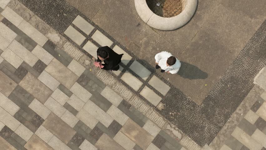 Fighting Kung Fu masters practicing martial arts moves outdoors from above