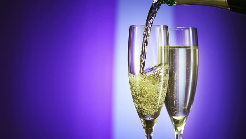 Champagne pouring in glass with festive background