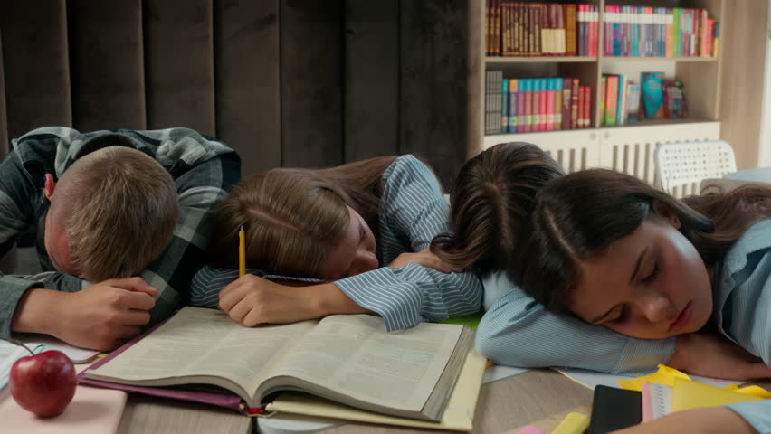 Caucasian four friends pupils tired exhausted fatigued students teens and teenagers boy guy male girls female at school library class sleeping napping on table books sleep together studying education - Powered by Shutterstock - Get 15% off with code: PIKWIZARD15