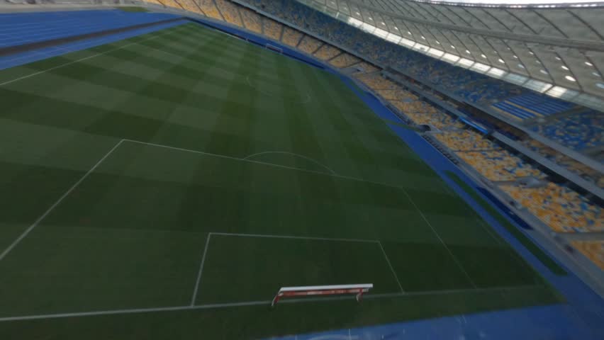 FPV flight, Stadium. cityscape time of day night. The view from the top to the illuminated stadium with games and fans. Stadium, Kiev, Ukraine, Soccer stadium field, soccer background, outdoor sport 