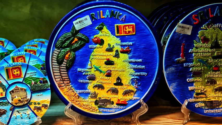 Closeup shot of a decorative plate depicting a map of Sri Lanka and highlighting various tourist attractions and cultural elements of the country.