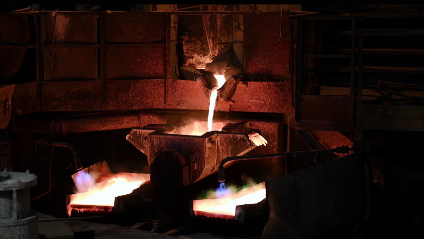 Melt copper metal poured down into casts on carousel machine