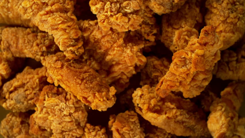 Super slow motion of flying tasty chicken pieces with camera movement. Filmed on high speed cinema camera, 1000 fps.