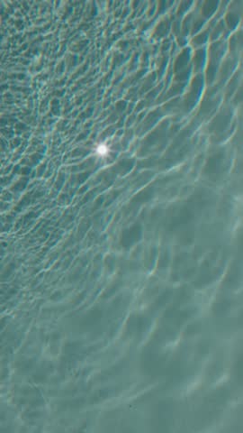 Sunlight Reflecting in Refreshing Pool Water Background Texture.