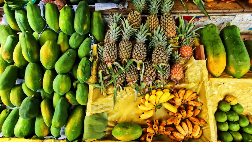Fresh tropical fruits like papayas, pineapples, bananas, and lemons displayed at a market stall in Yala National Park, Sri Lanka - Powered by Shutterstock - Get 15% off with code: PIKWIZARD15