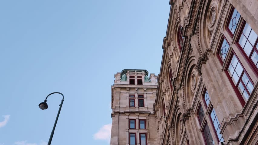Detailed stone facade of a historic building with arched windows in Vienna, Austria