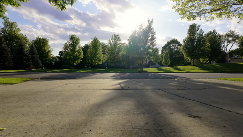 Woman is walking with the dog at the residential area. sunset time. Slow motion wide view