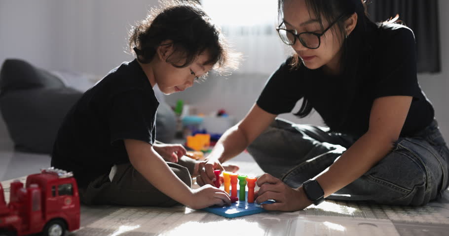 mother and son enjoy a playful learning moment with a sensory toy. Parenting, childhood, bonding, education, creativity, fine motor skills, interaction, fun. 4K.