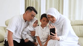 Happy Muslim Family Video Calling on Smartphone at Home - Powered by Shutterstock - Get 15% off with code: PIKWIZARD15